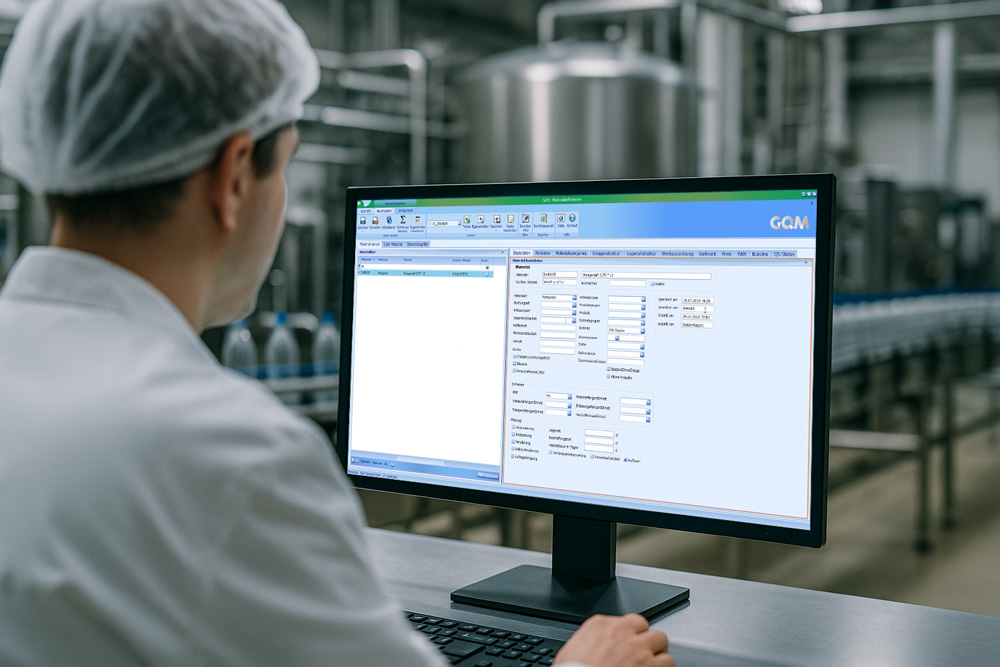 Mitarbeiter in Produktionshalle überwacht die Datenübernahme im GQM MES-System.